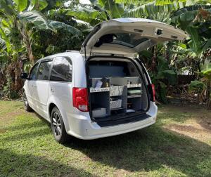 a white van with its doors open with its trunk open at HW Campervan Rental NO CAMPGROUND in Hauula