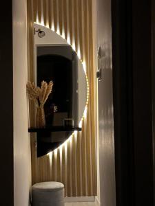 a bathroom with a hallway with a mirror and lights at Saguna Residence2 in Sighişoara