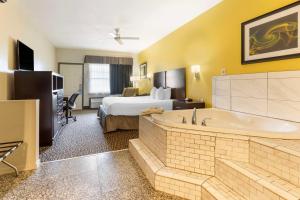 a hotel room with a bed and a bath tub at Best Western West Monroe Inn in West Monroe +28 photos