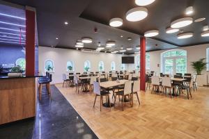 a restaurant with tables and chairs in a room at Best Western Plus Hotel Rzeszow City Center in Rzeszów