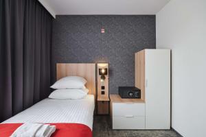 a hotel room with a bed and a tv at Best Western Plus Hotel Rzeszow City Center in Rzeszów