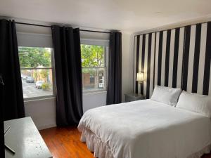 a bedroom with a bed and a large window at Luxury Fitzroy House in Melbourne