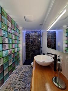 a bathroom with a sink and a shower with tiles at Casa do Poço in Santa Bárbara +82 photos