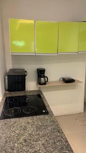 a kitchen with a stove and green cabinets at Habitación en suite in Fernando de la Mora