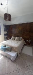 a bedroom with a large bed with a wooden headboard at Aguará ibá in San Juan