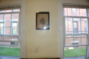 a hallway with two windows and a picture on the wall at Historic West End Gem in Hartford