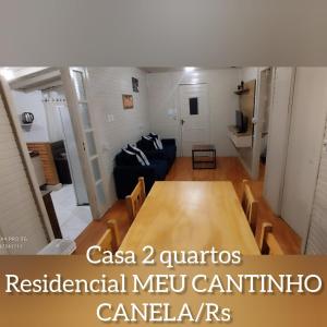 a living room with a table and a couch at RESIDENCIAL MEU CANTINHO in Canela