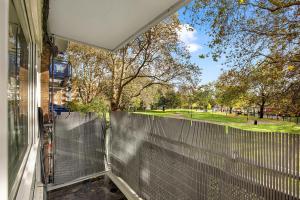 a screened in porch with a view of a yard at Peckham apartments by APS in London