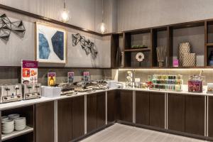 a kitchen with wooden cabinets and a counter top at Residence Inn by Marriott Boston Waltham in Waltham