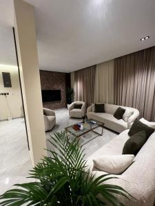 sala de estar con sofá y mesa en رهف ريزيدنس Rahaf smart residence en Riad