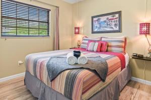 a bedroom with a bed with two towels on it at Riverfront Oasis Stunning Inside and Out Remodeled 3BR Riverfront Home with Hot Tub and personal paddle boats with Access to the Gulf in Riverview