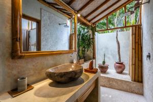 a bathroom with a large bowl sink on a counter at Villa Burung Gili Air Authentic 3-Bedroom Bamboo Villa with Private Pool in Gili Air