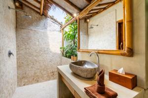 a bathroom with a sink and a shower at Villa Burung Gili Air Authentic 3-Bedroom Bamboo Villa with Private Pool in Gili Air