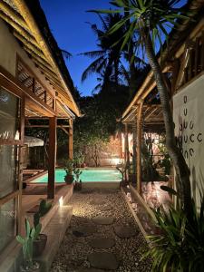a resort with a swimming pool and a house at Villa Burung Gili Air Authentic 3-Bedroom Bamboo Villa with Private Pool in Gili Air