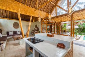 an open kitchen and living room in a house at Villa Burung Gili Air Authentic 3-Bedroom Bamboo Villa with Private Pool in Gili Air