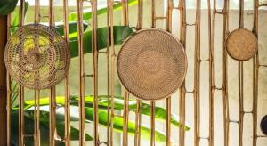 two baskets and some green vegetables in a cage at Villa Burung Gili Air Authentic 3-Bedroom Bamboo Villa with Private Pool in Gili Air