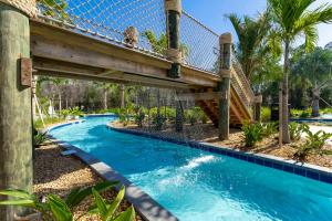 a bridge over a swimming pool in a resort at NEW to Market 5 Bed - Storey Lake Retreat in Kissimmee
