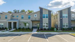 a large apartment building with a parking lot at NEW to Market 5 Bed - Storey Lake Retreat in Kissimmee