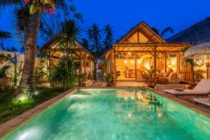 an exterior view of a house with a swimming pool at Villa Burung Gili Air Authentic 3-Bedroom Bamboo Villa with Private Pool in Gili Air
