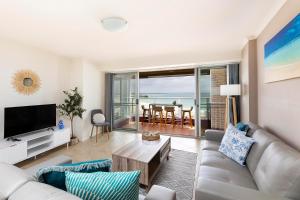 a living room with a couch and a table at El Sandi Unit 06 in Forster