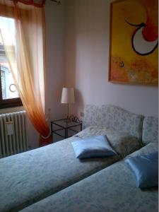 a bed sitting in a bedroom with a window and a bed sidx sidx at B&B Brera in Milan