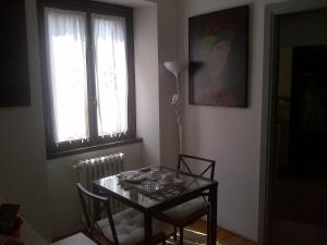 a dining room with a table and chairs and a window at B&B Brera in Milan