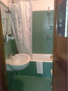 a bathroom with a sink and a shower and a tub at B&B Brera in Milan