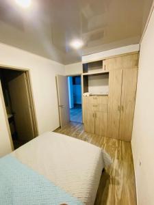 a bedroom with a white bed and wooden floors at la martina in San Francisco