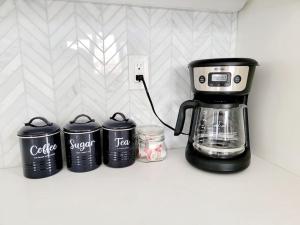 a coffee maker and four trash cans on a counter at Park View Balboa Townhouse Modern Upscale 3 Bed in San Diego