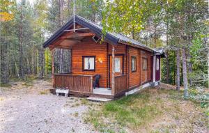 a wooden cabin in the middle of a forest at Stuga 1 in Nybro