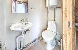 a bathroom with a toilet and a sink at Stuga 1 in Nybro