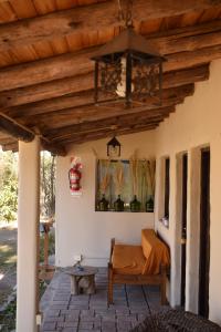 a porch with a bed and a wooden ceiling at Tiempo de Bienestar in Potrerillos
