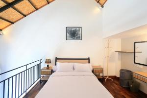a bedroom with a large bed with white sheets at ND LOFT 2 by Kasta Hospitality in Canggu +29 photos