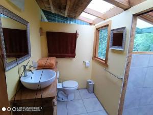 a bathroom with a sink and a toilet at Riverside Studio- Hush Valley Lodge in Río Blanco
