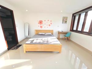 Ein Bett oder Betten in einem Zimmer der Unterkunft KENPI Homestay