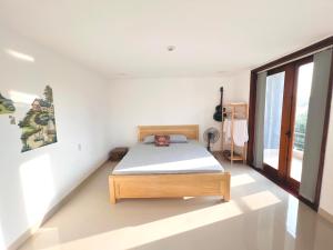 Ein Bett oder Betten in einem Zimmer der Unterkunft KENPI Homestay