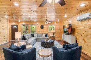 a living room with a couch and a tv at Brand New Luxury Cabin-Private Appalachian Retreat in Gatlinburg
