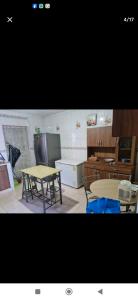 a kitchen with two tables and a table and a counter at Hospedaje Portobelo in Portobelo