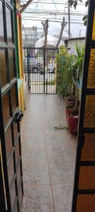 an open door to a courtyard with potted plants at Residencial La Nona - Villa Alemana in Villa Alemana