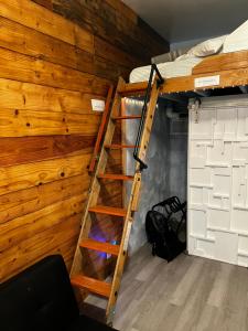 a bunk bed in a room with a wooden wall at 200 Direct Access in Los Angeles
