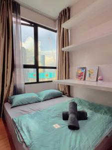 a bed in a room with a large window at Homely 2BR, Free Carpark @ Direct Link Central Mall, SOGO, Theme Park in Shah Alam