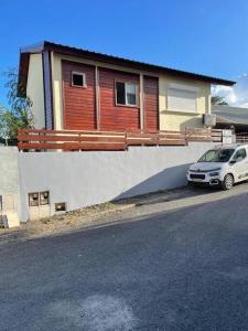 a car parked in front of a house at Belle maison équipé avec piscine in Mamoudzou
