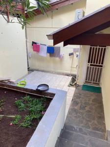 a house with towels hanging on a clothes line at Belle maison équipé avec piscine in Mamoudzou