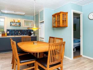 a kitchen and dining room with a wooden table and chairs at Two-Bedroom Holiday home in Ans By 2 in Ans