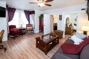 a living room with a couch and a table at Vintage downtown flat near Holy Hill, Golf &Ski in Hartford