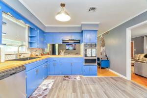 eine Küche mit blauen Schränken und ein Wohnzimmer in der Unterkunft Capital City Eagle's Nest - Pool Table - Pet Friendly - 6 beds in Montgomery