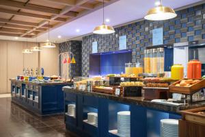 a buffet line in a restaurant with food at Holiday Inn Express Beijing Downtown, an IHG Hotel in Beijing