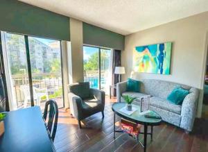 a living room with a couch and a table at 2BR Condo 1 mile from Universal in Orlando