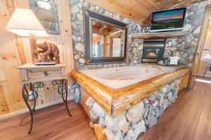 a bathroom with a large stone tub in a cabin at The Burgundy in Big Bear Lake +250 photos