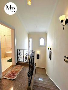a hallway with a staircase and a bathroom at Villa Marina (5) 2nd Row Of The Sea in El Alamein